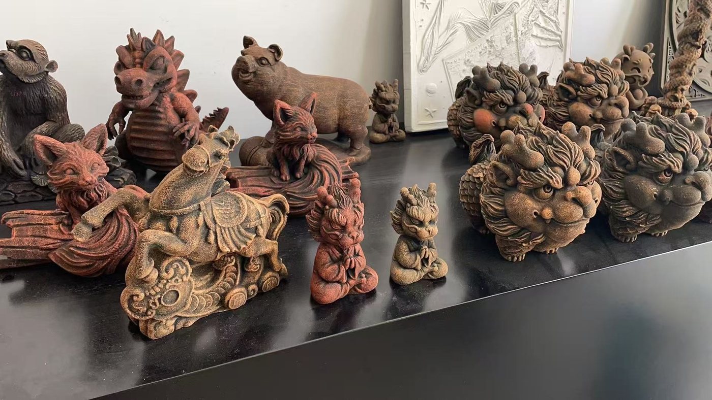 Shelf of dragon, fox, horse and pig figurines with a textured rust colored finish