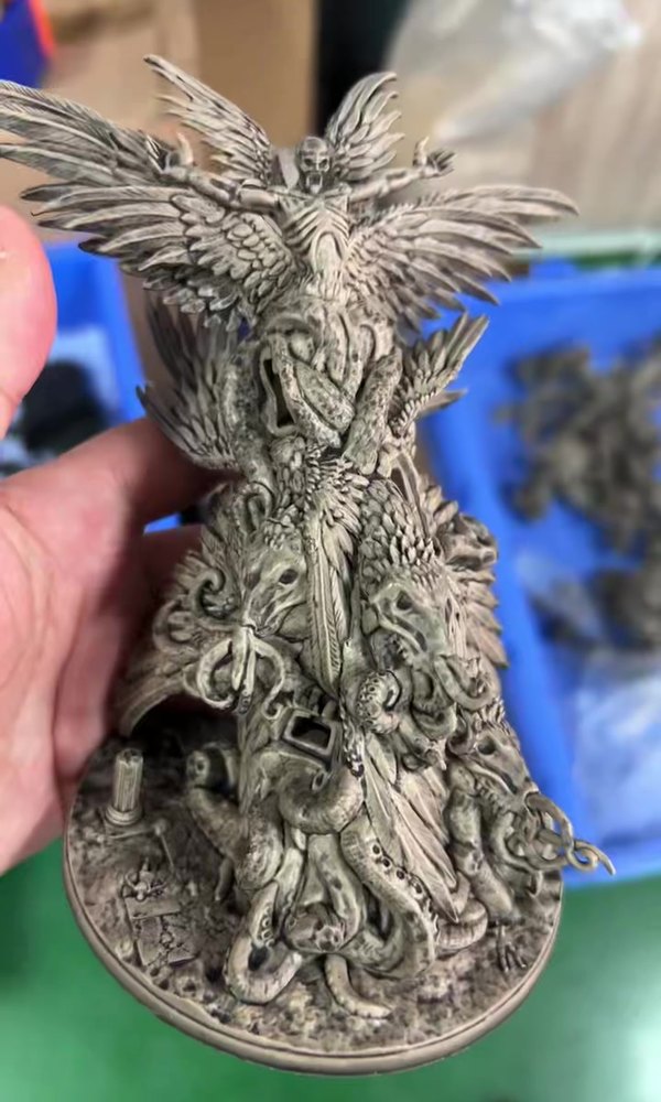 Unpainted grey miniature sample of a fantasy character on a round base
